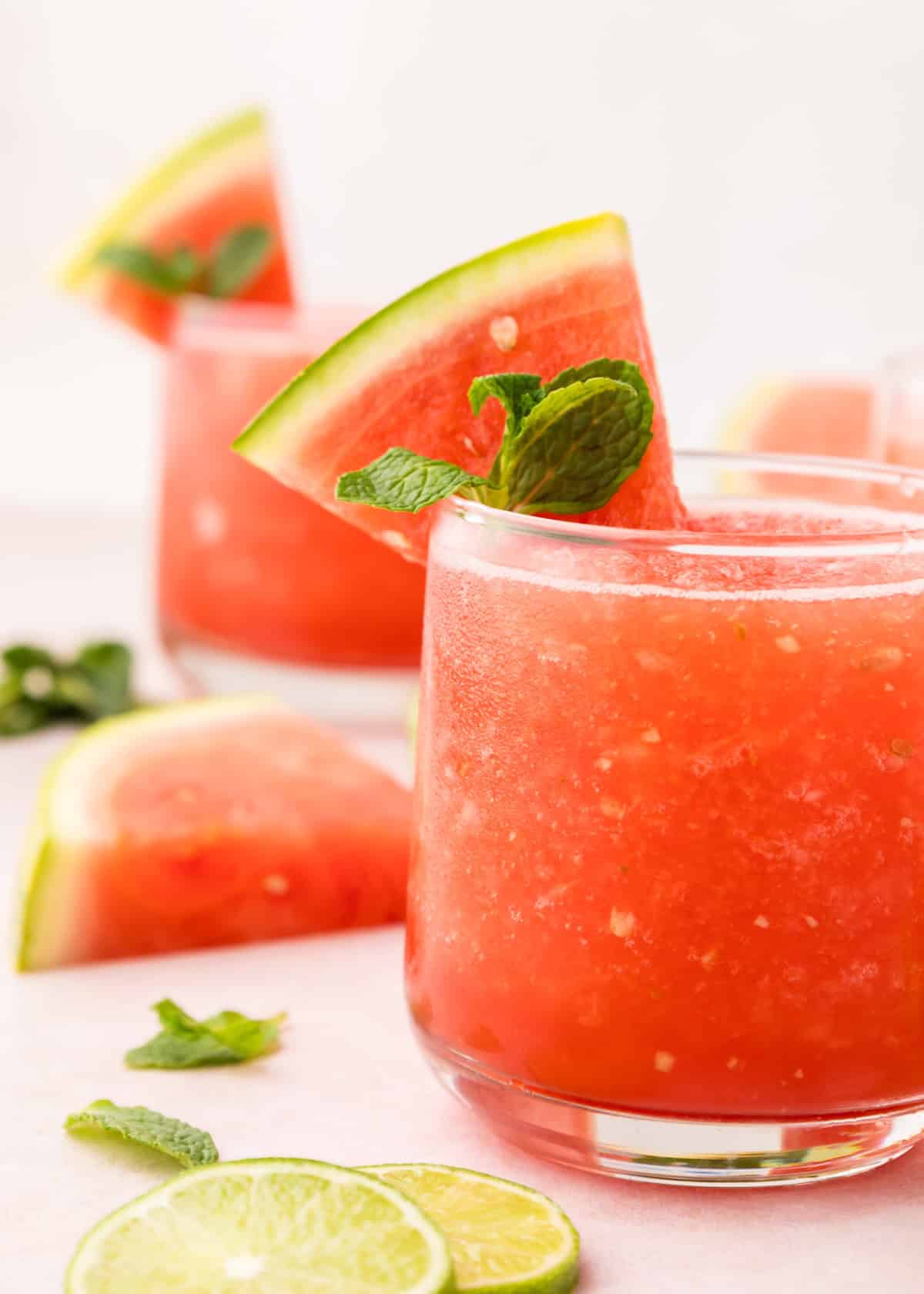 Watermelon Slushy with a sprig of mint and watermelon slice.