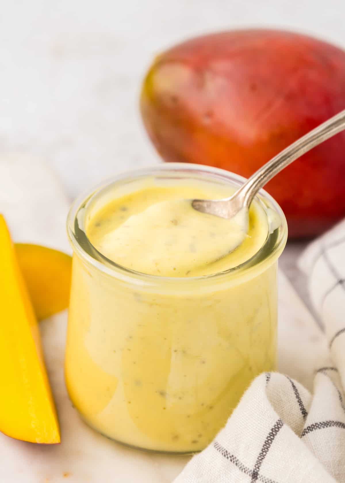 A small jar of remoulade with a spoon.