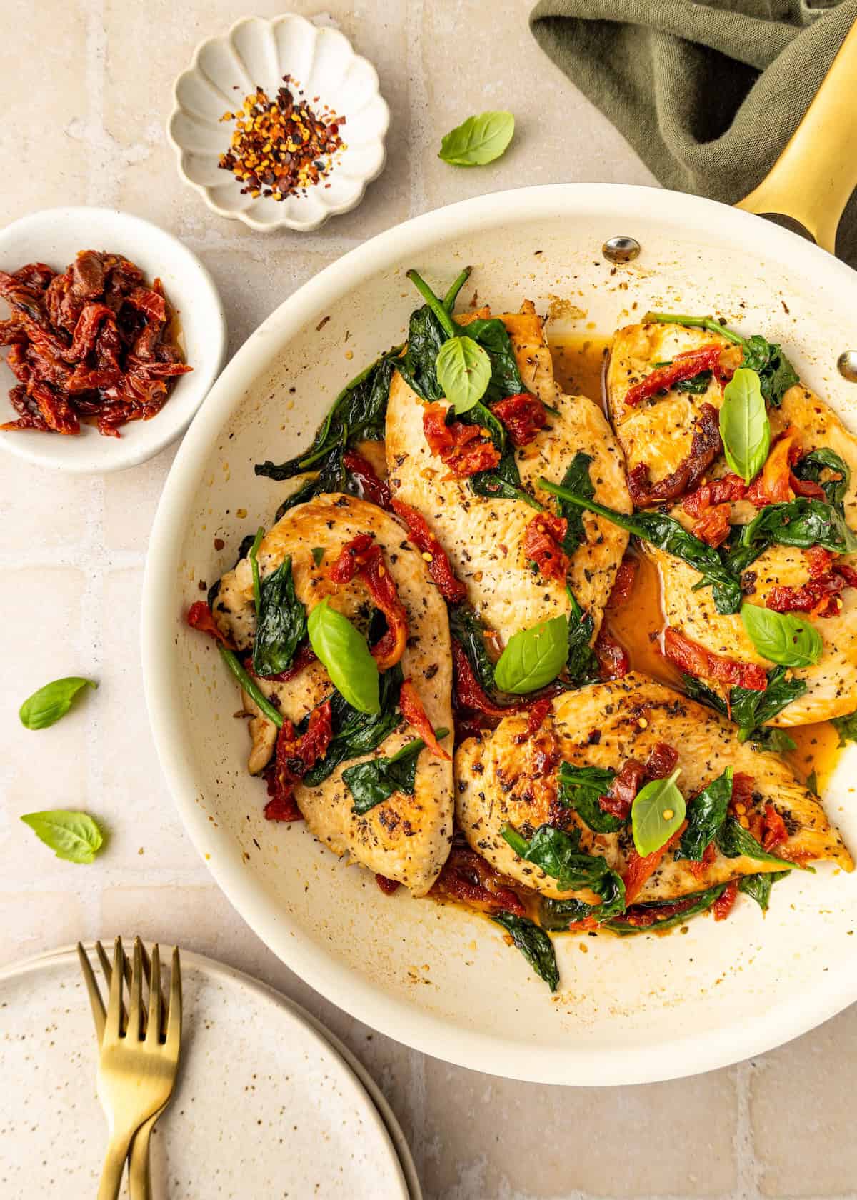 Sun-dried tomato chicken breasts sautéed with spinach and finished with fresh basil leaves.