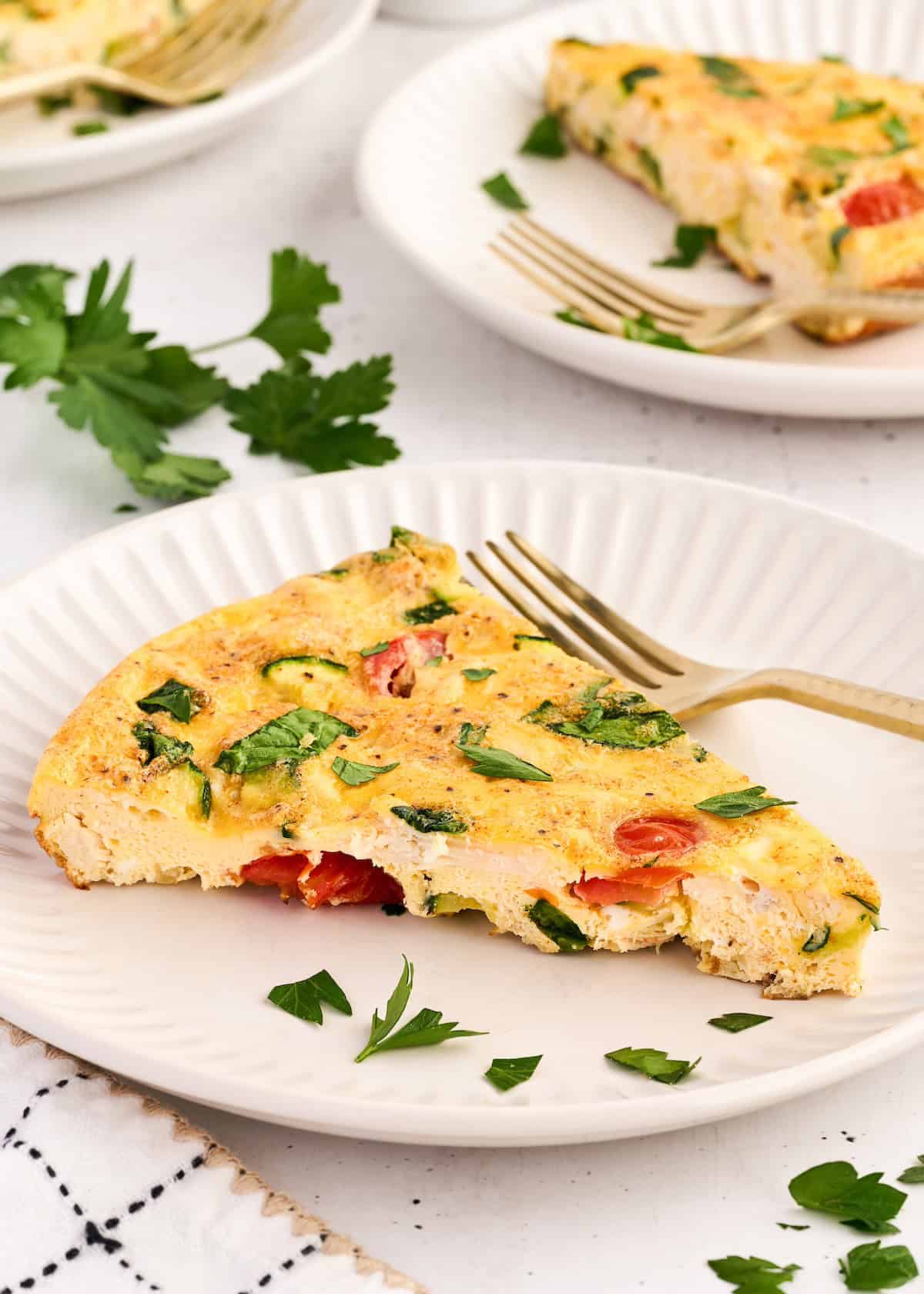 slice of chicken frittata on a plate.