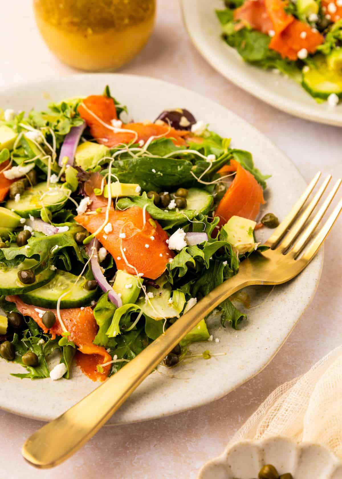 Smoked Salmon Salad on plate with golden fork.