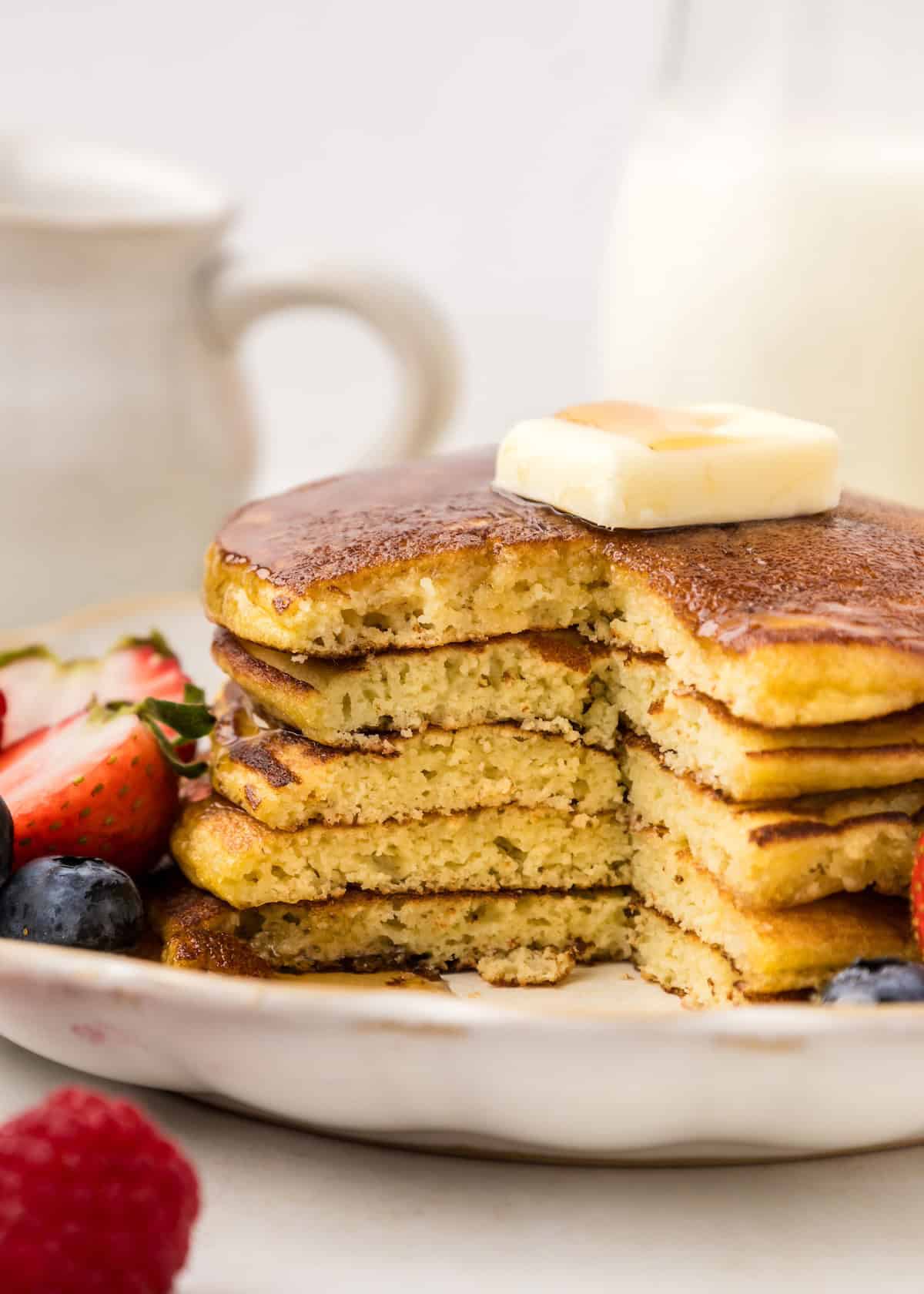 Coconut flour pancakes with berries and butter, sliced.