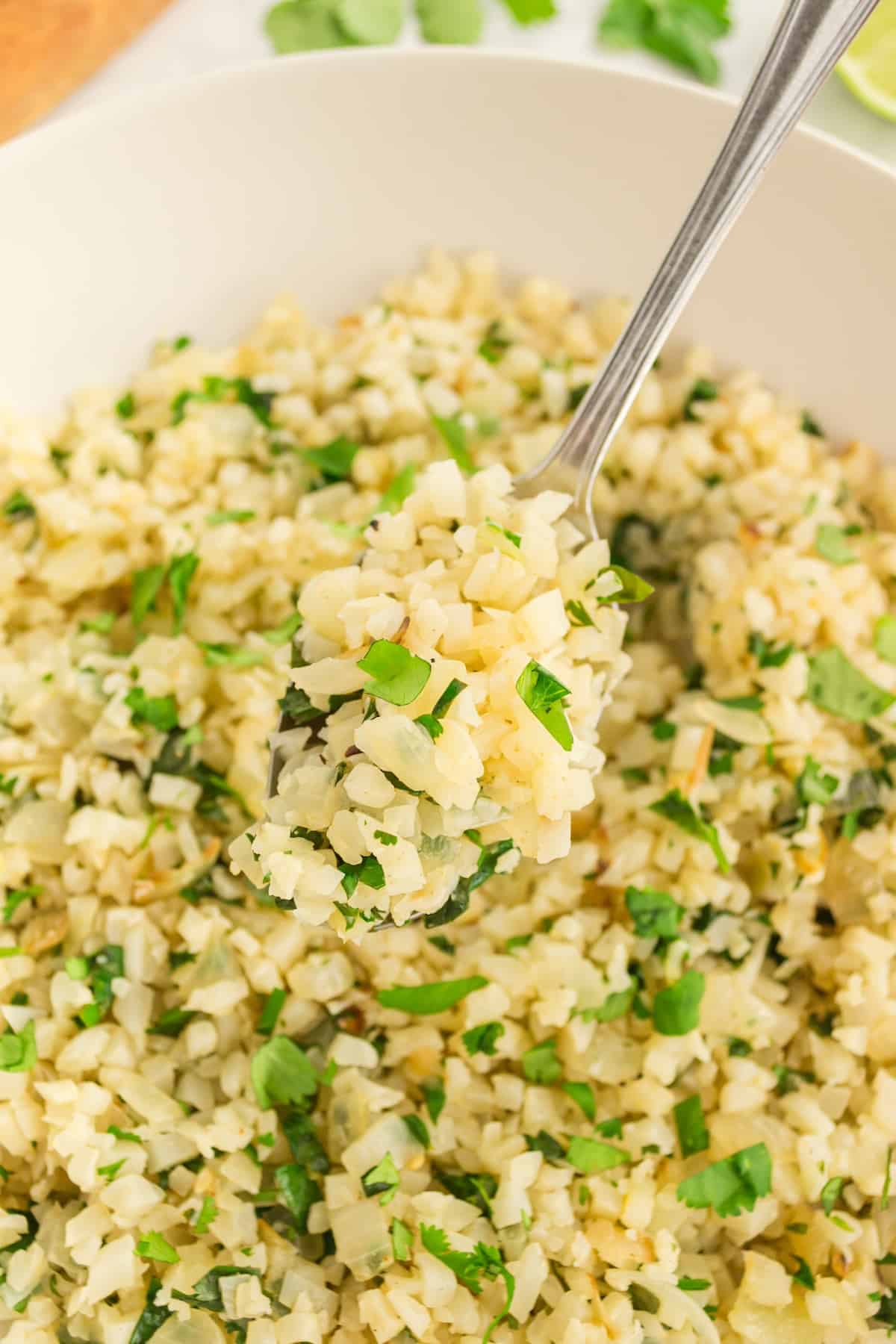 cilantro lime cauliflower rice scooped out with spoon