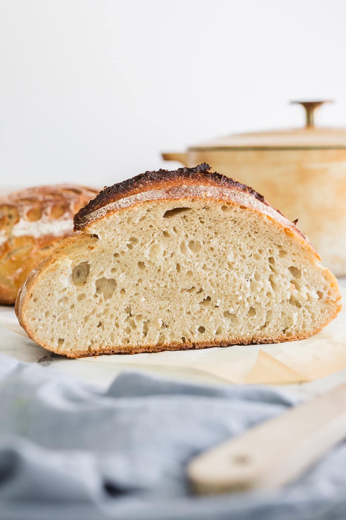 Sliced sourdough bread with a crispy top and soft inside.