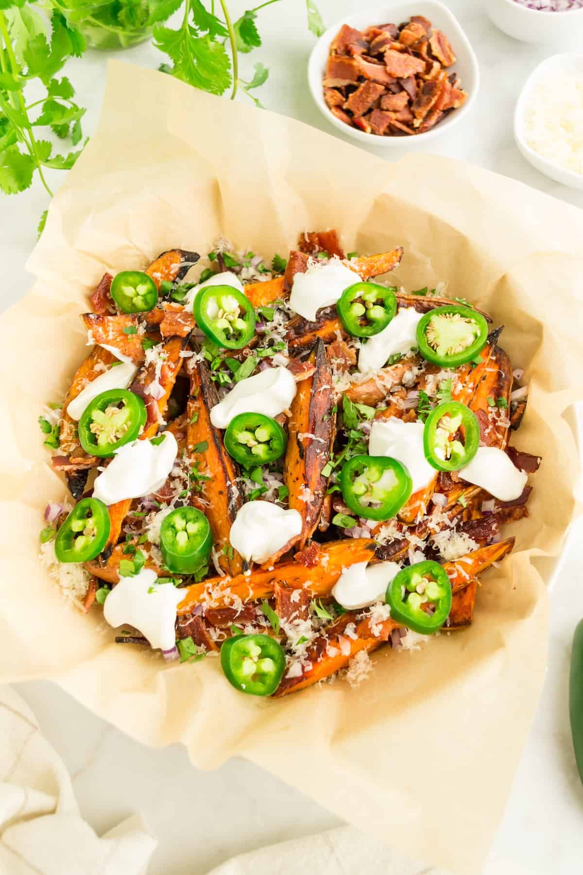Loaded sweet potato fries topped with jalapenos and sour cream.
