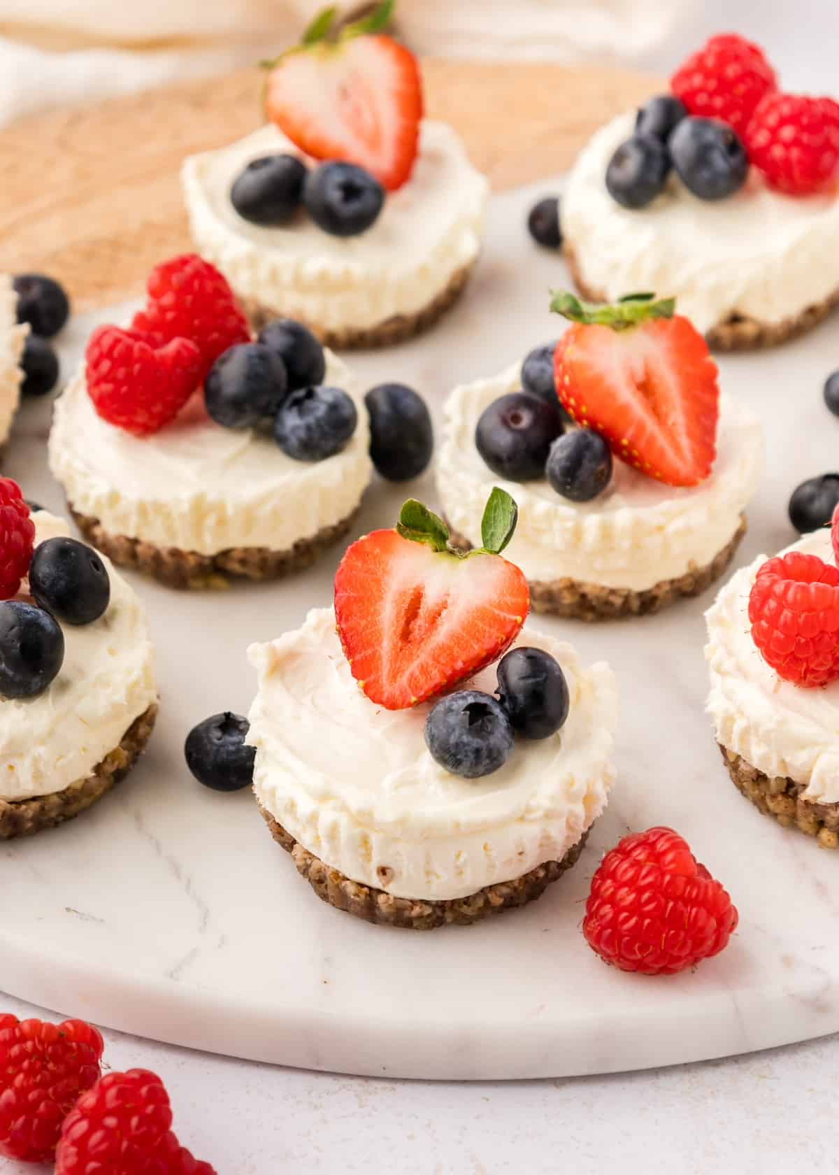 no bake mini cheesecakes topped with strawberry and blueberries