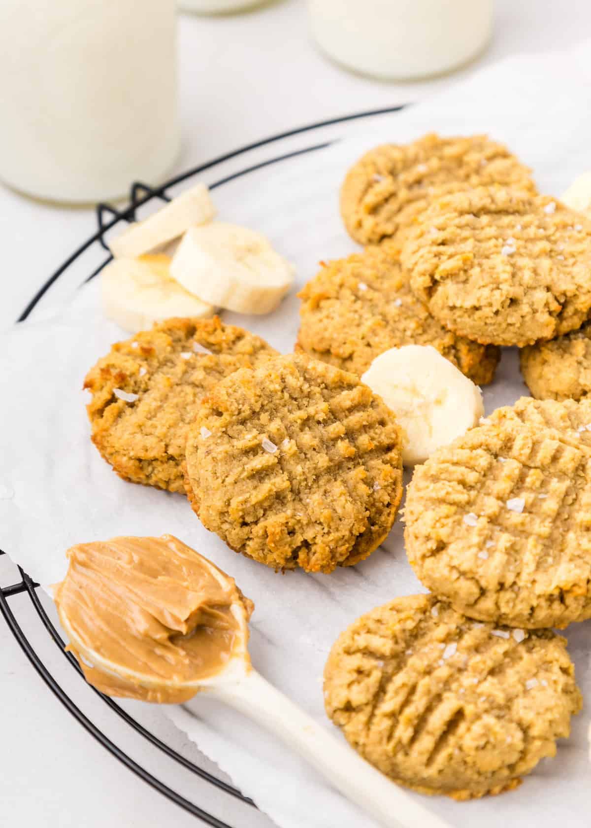 Peanut butter banana cookies on wire rack with banana slices.