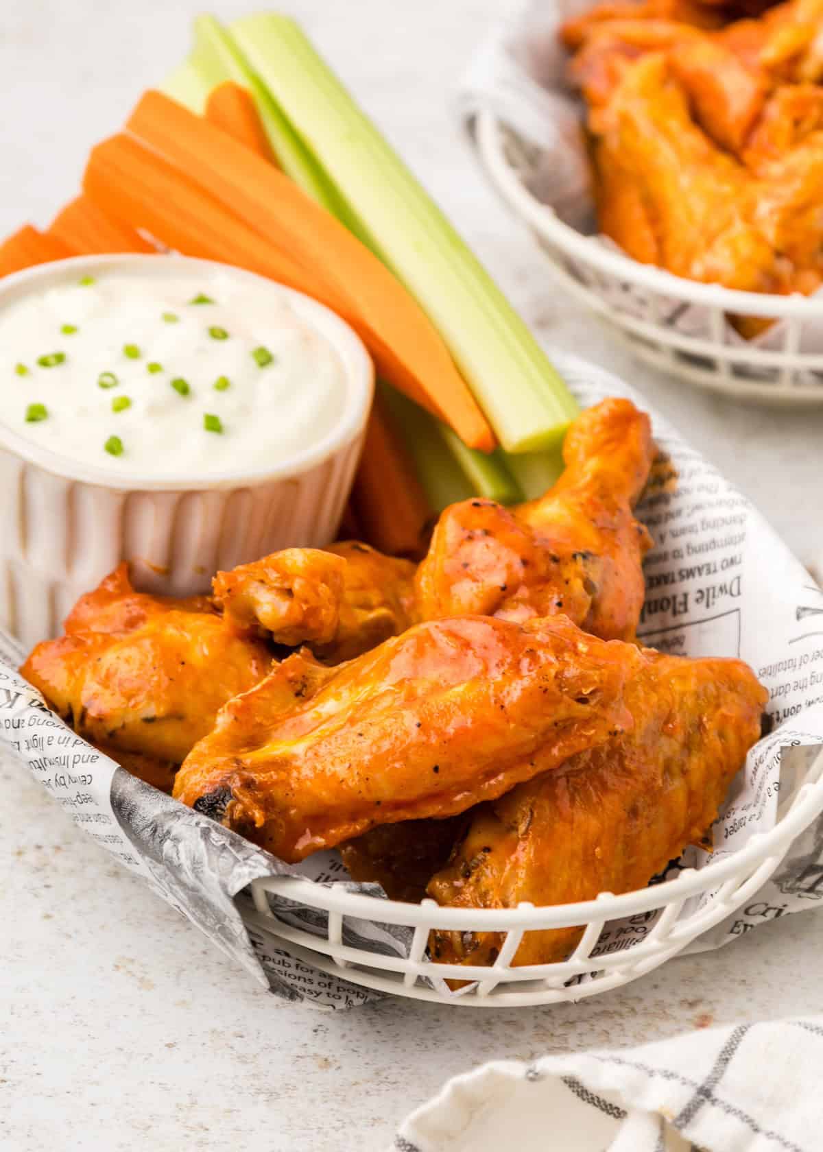 Baked buffalo chicken wings served with carrots and celery and blue cheese.