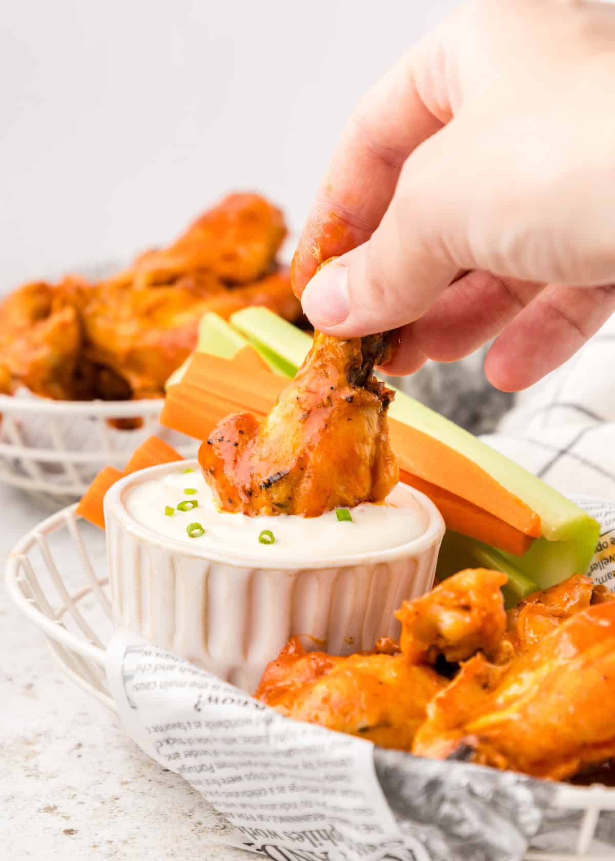 Baked buffalo chicken wings dipped in blue cheese.