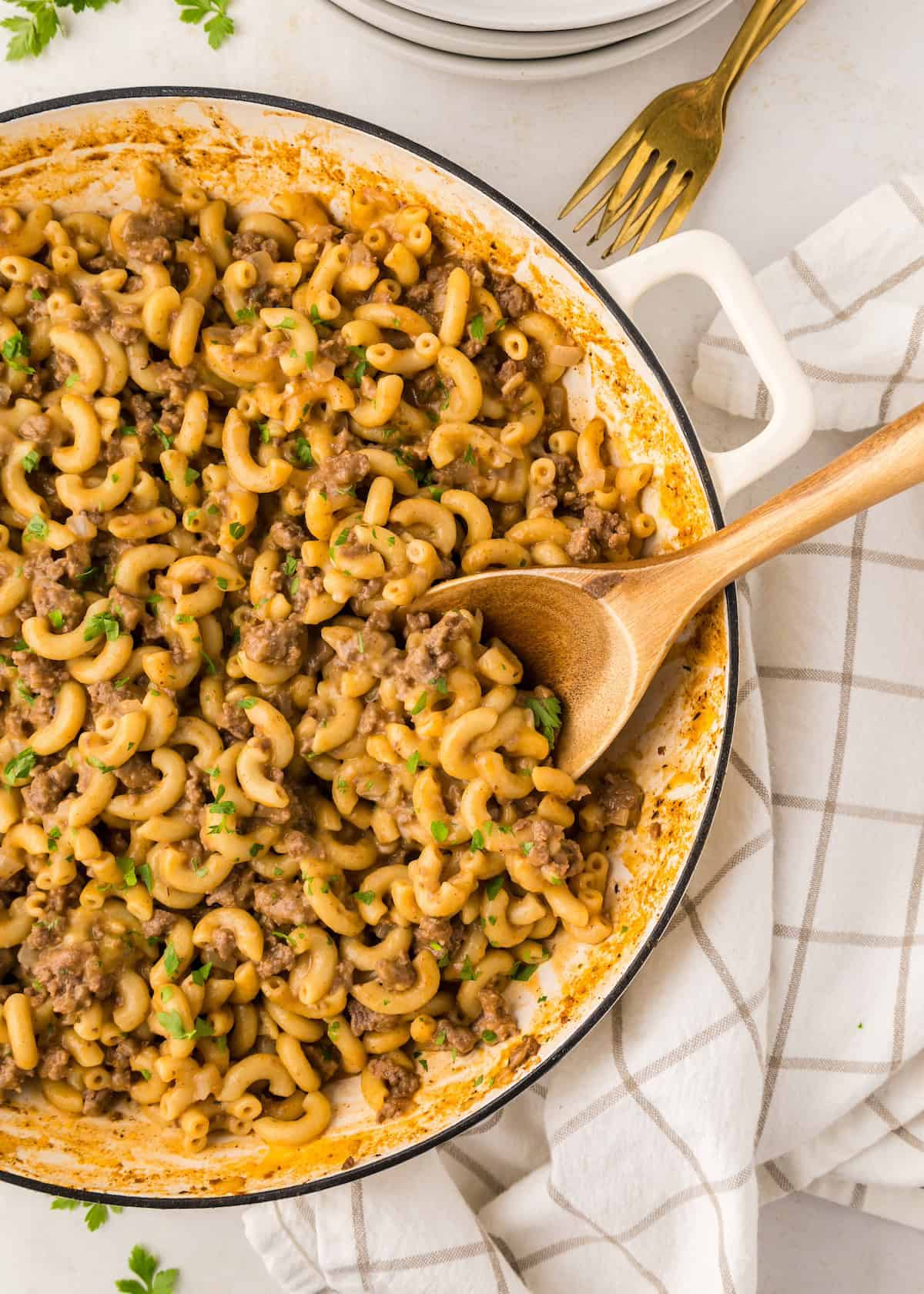 Homemade hamburger helper with wooden spoon.
