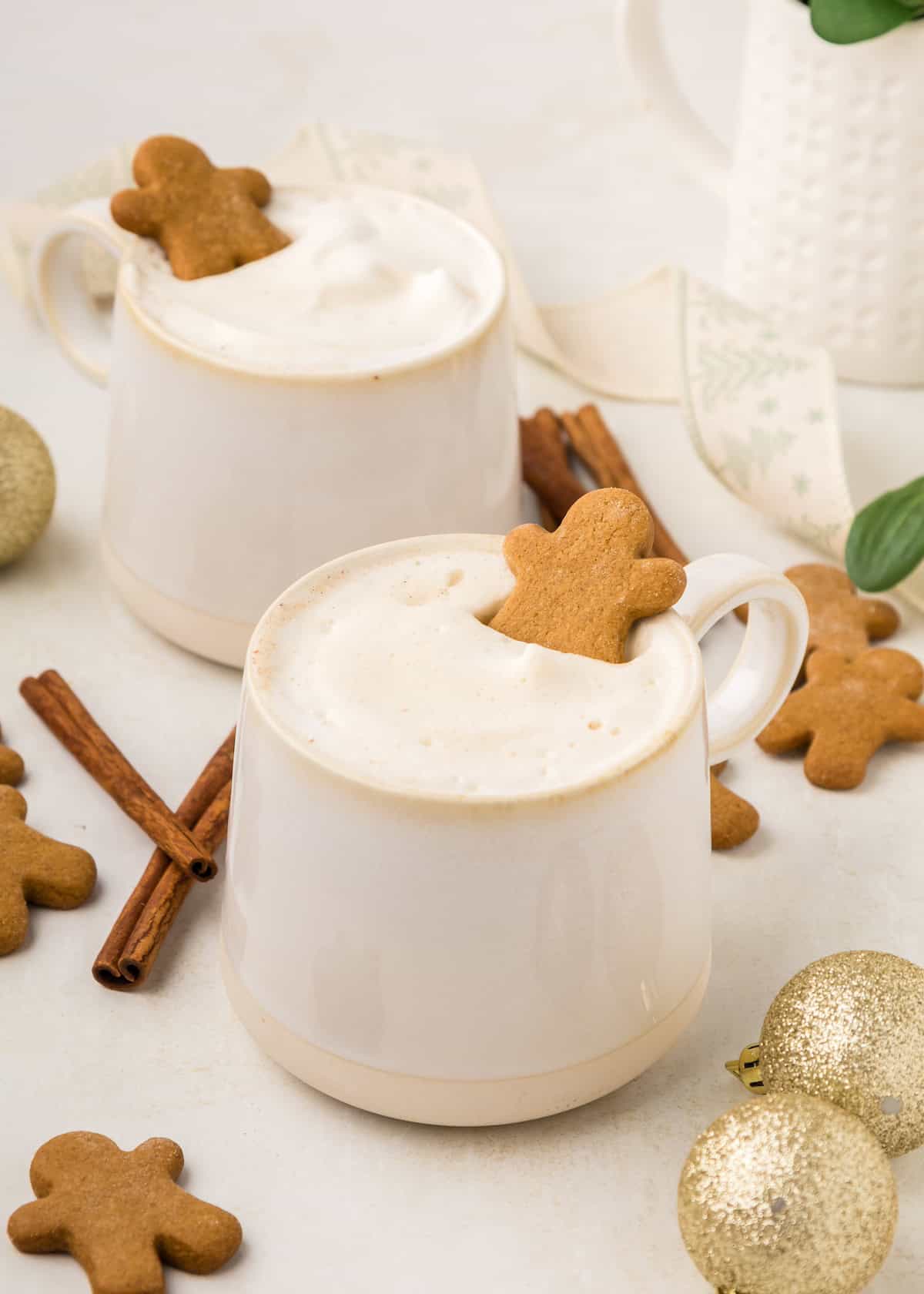 Gingerbread latte with gingerbread men and cinnamon sticks.