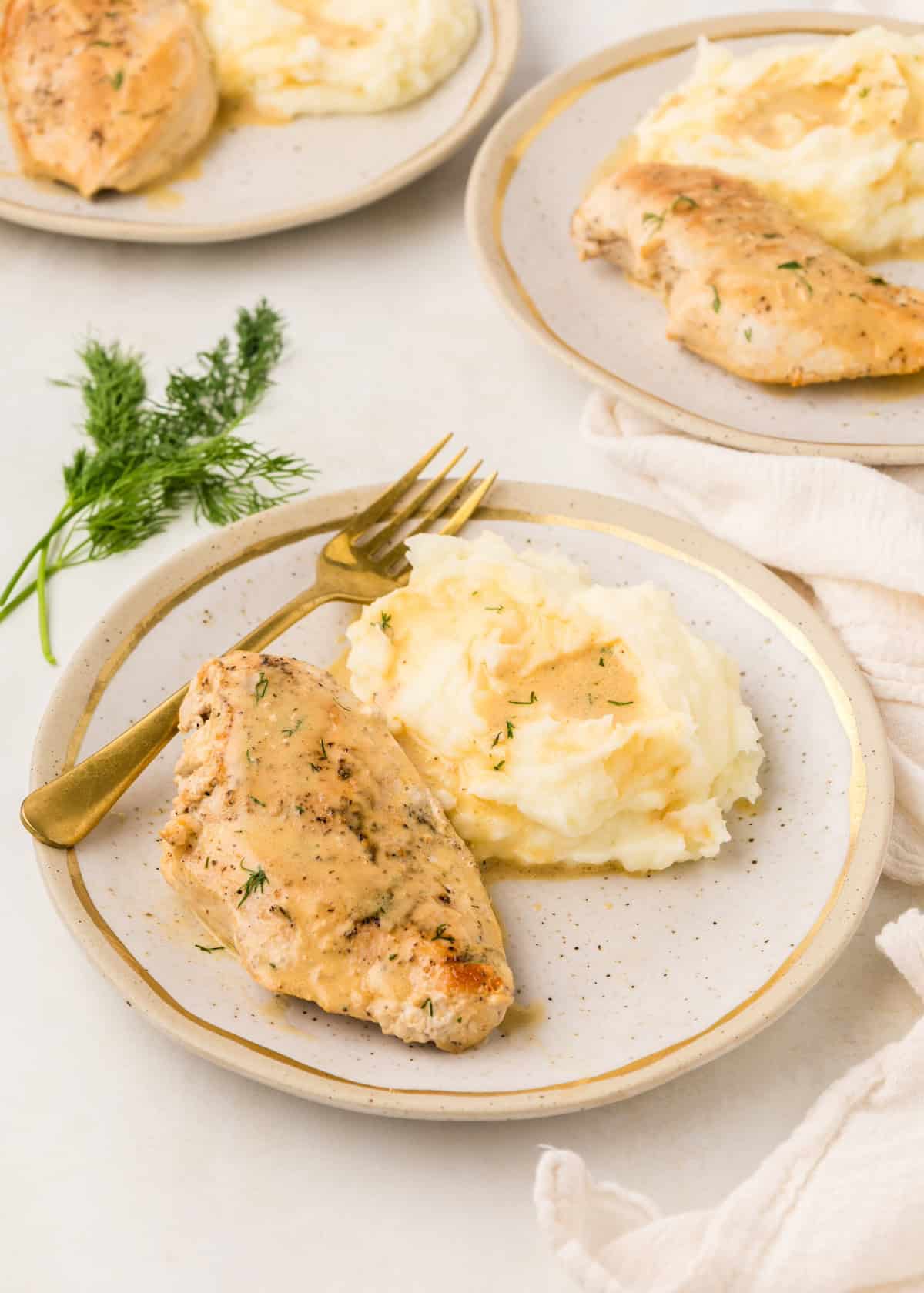 Dijon chicken with mashed potatoes served on plates.