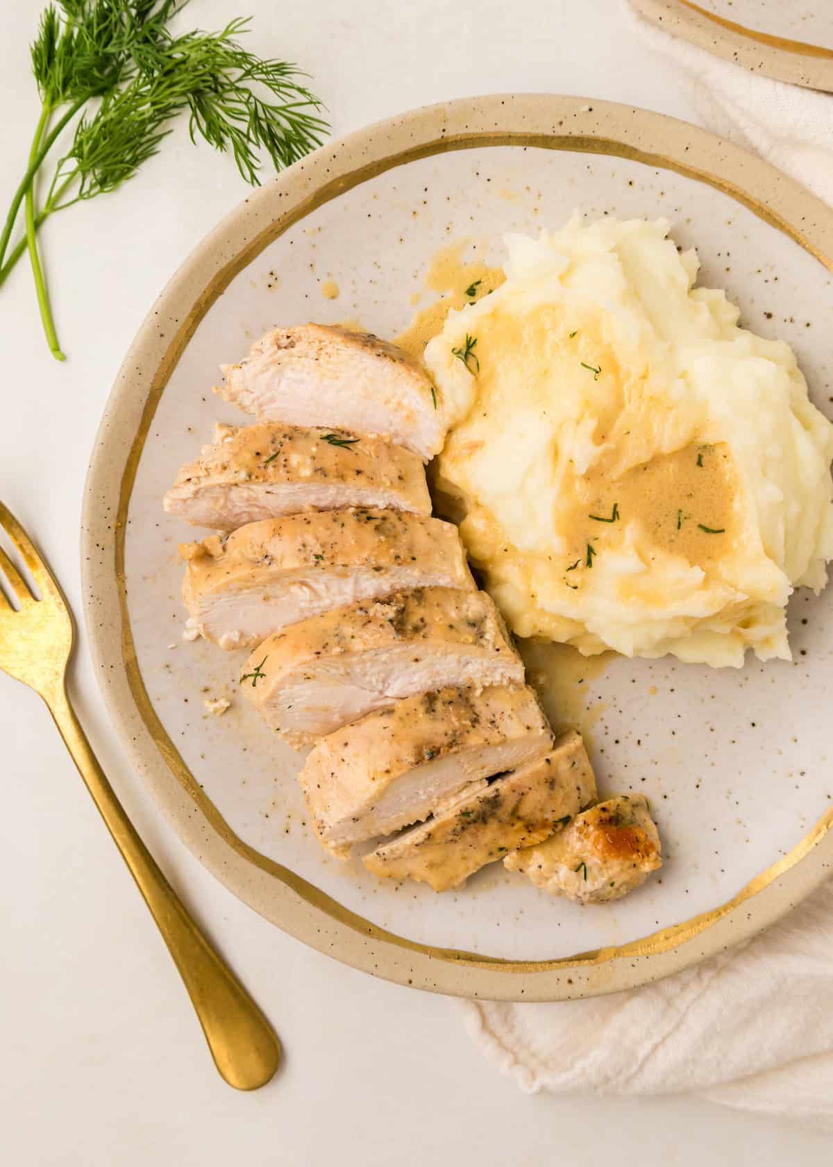 Dijon chicken served with mashed potatoes and topped with sauce.