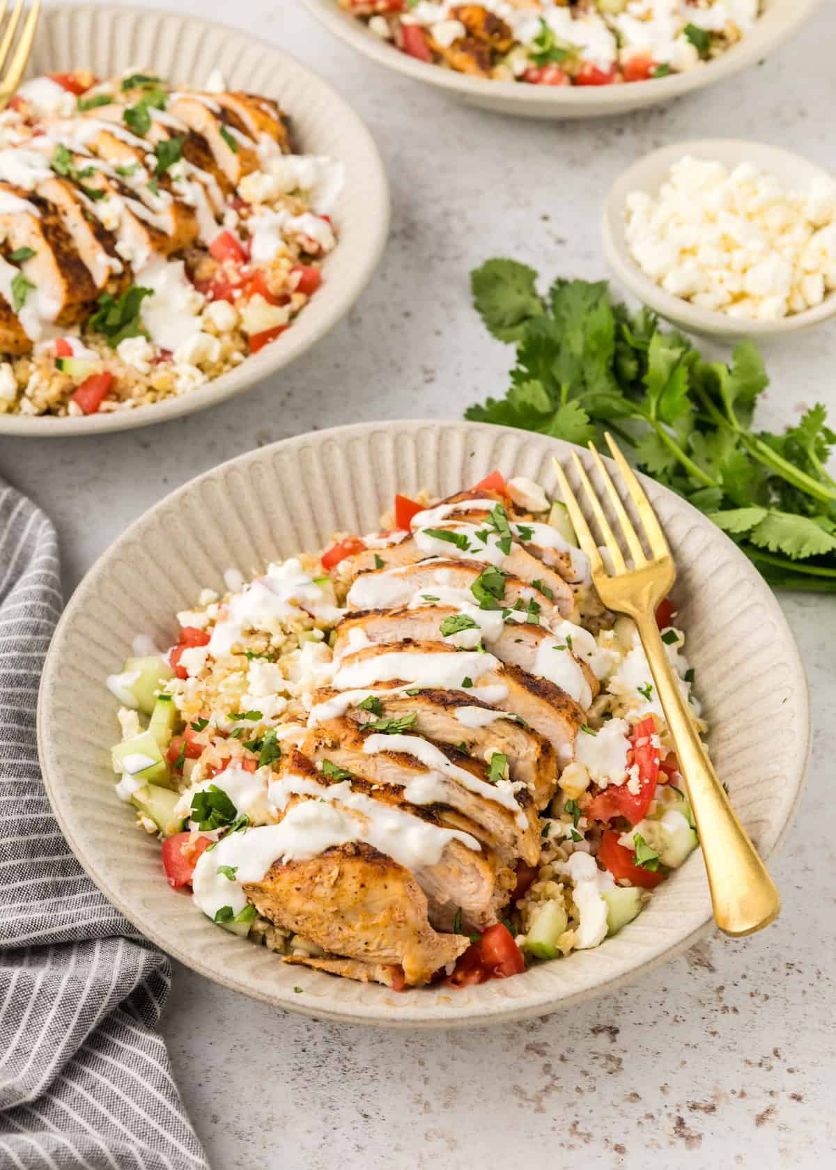 Chicken Tabbouleh served in bowls with sauce.