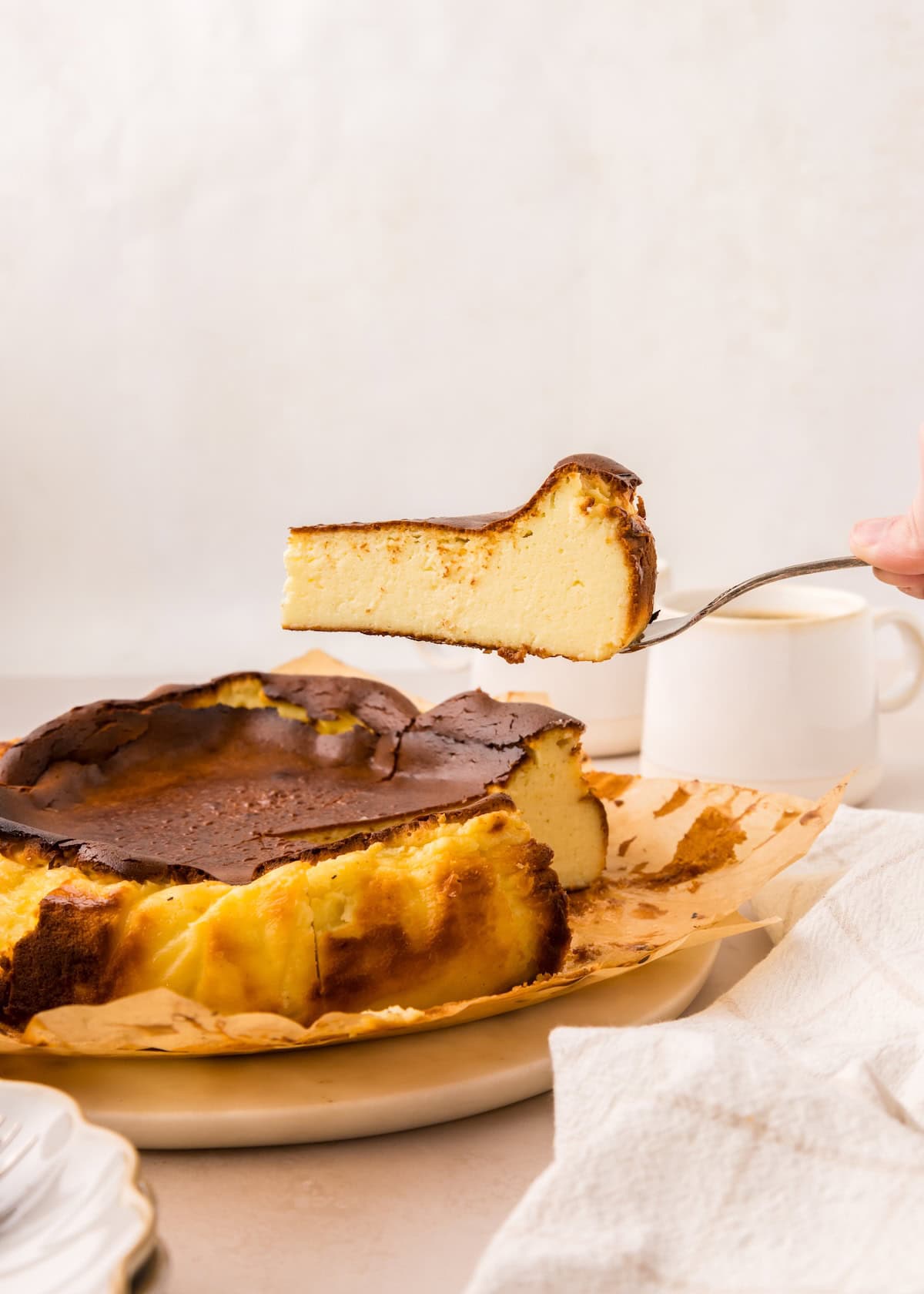 Lifting out a slice of Basque Cheesecake.