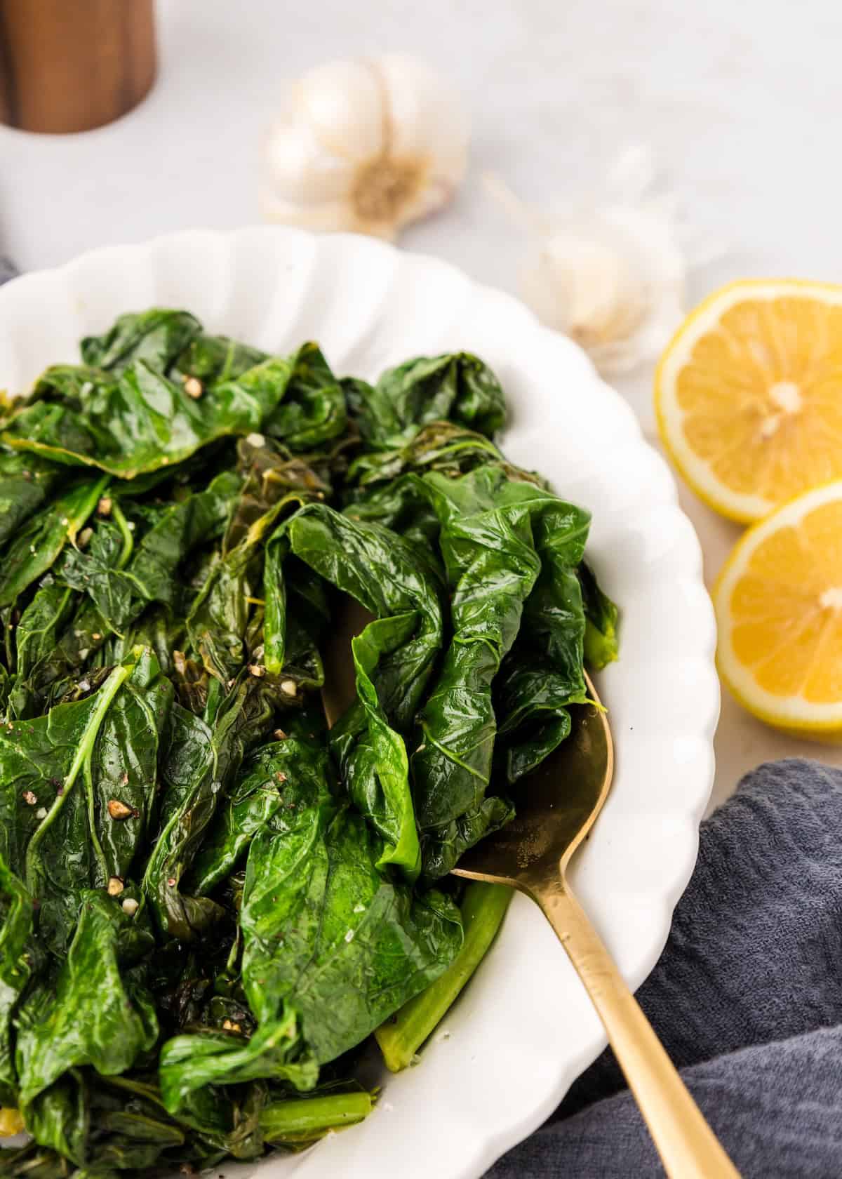 Turnip Greens being served from a white platter.