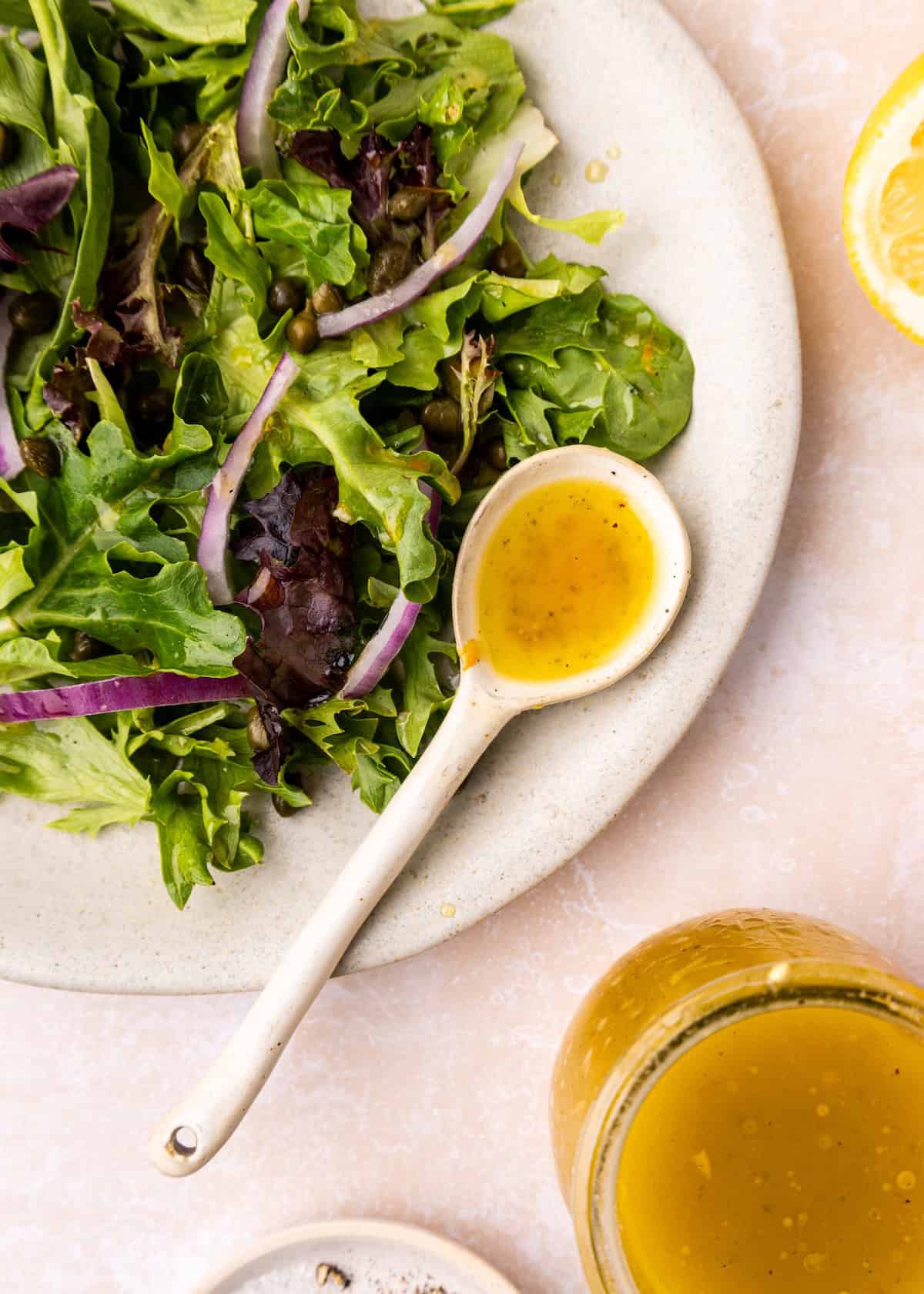 Spoonful of Citrus Vinaigrette with salad.