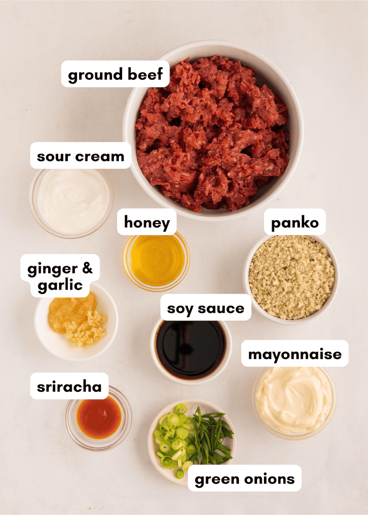 Ingredients for Firecracker Meatballs in labeled bowls: ground beef, panko, sriracha, soy sauce.