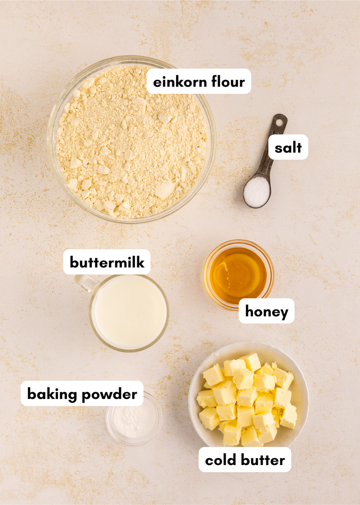 Bowl of Einkorn Biscuits ingredients: einkorn flour, honey, buttermilk, baking powder, butter.